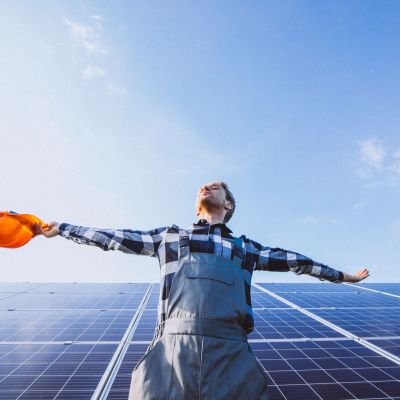 man worker firld by solar panels scaled